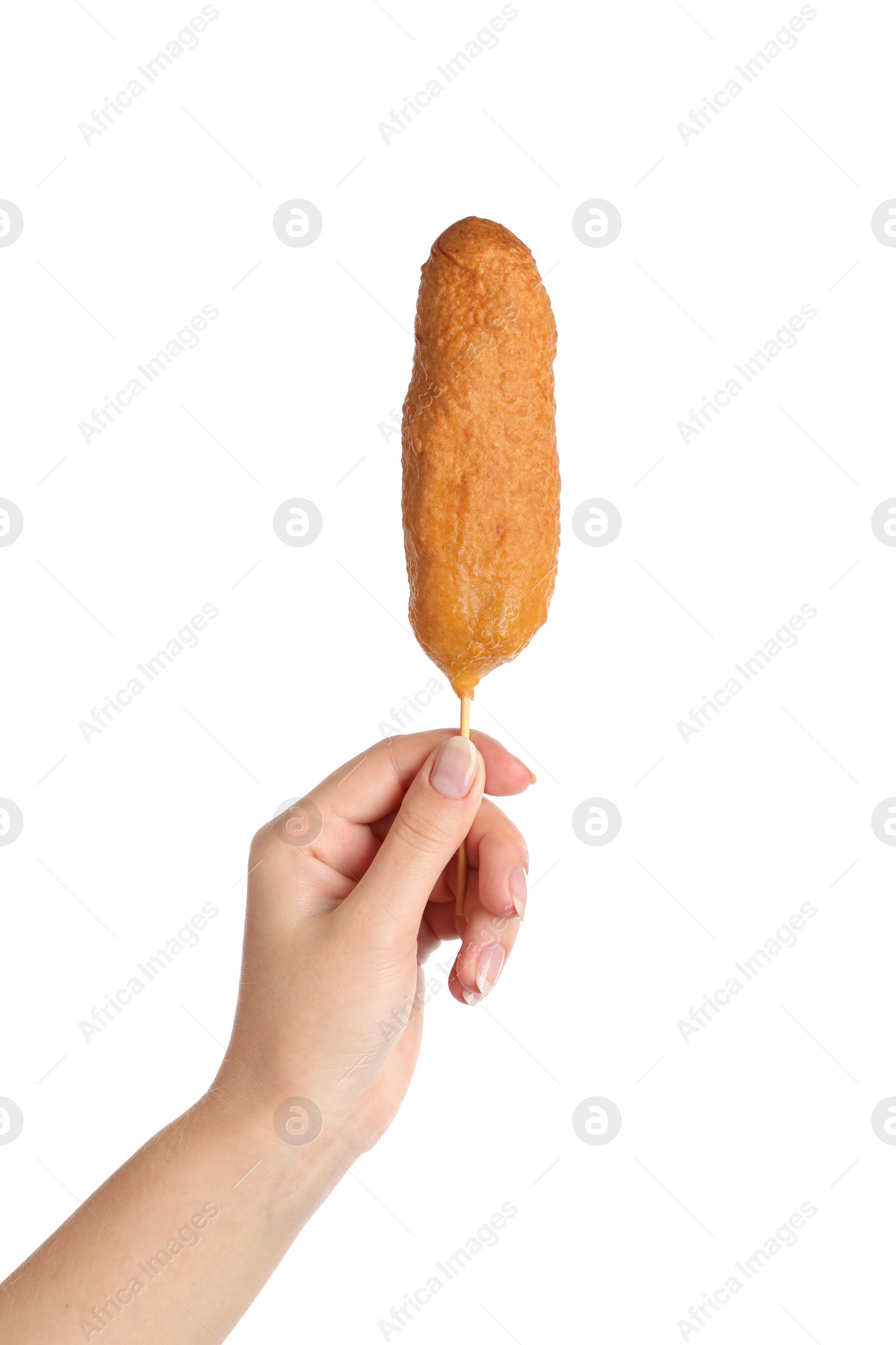 Photo of Woman holding delicious deep fried corn dog on white background, closeup