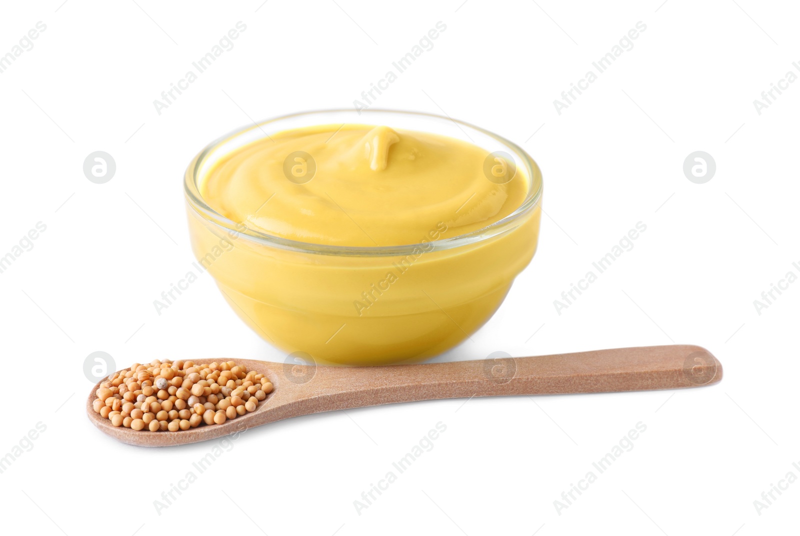 Photo of Bowl of delicious mustard and spoon with seeds on white background