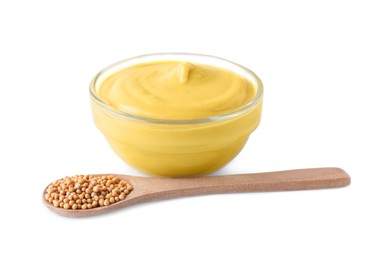 Photo of Bowl of delicious mustard and spoon with seeds on white background