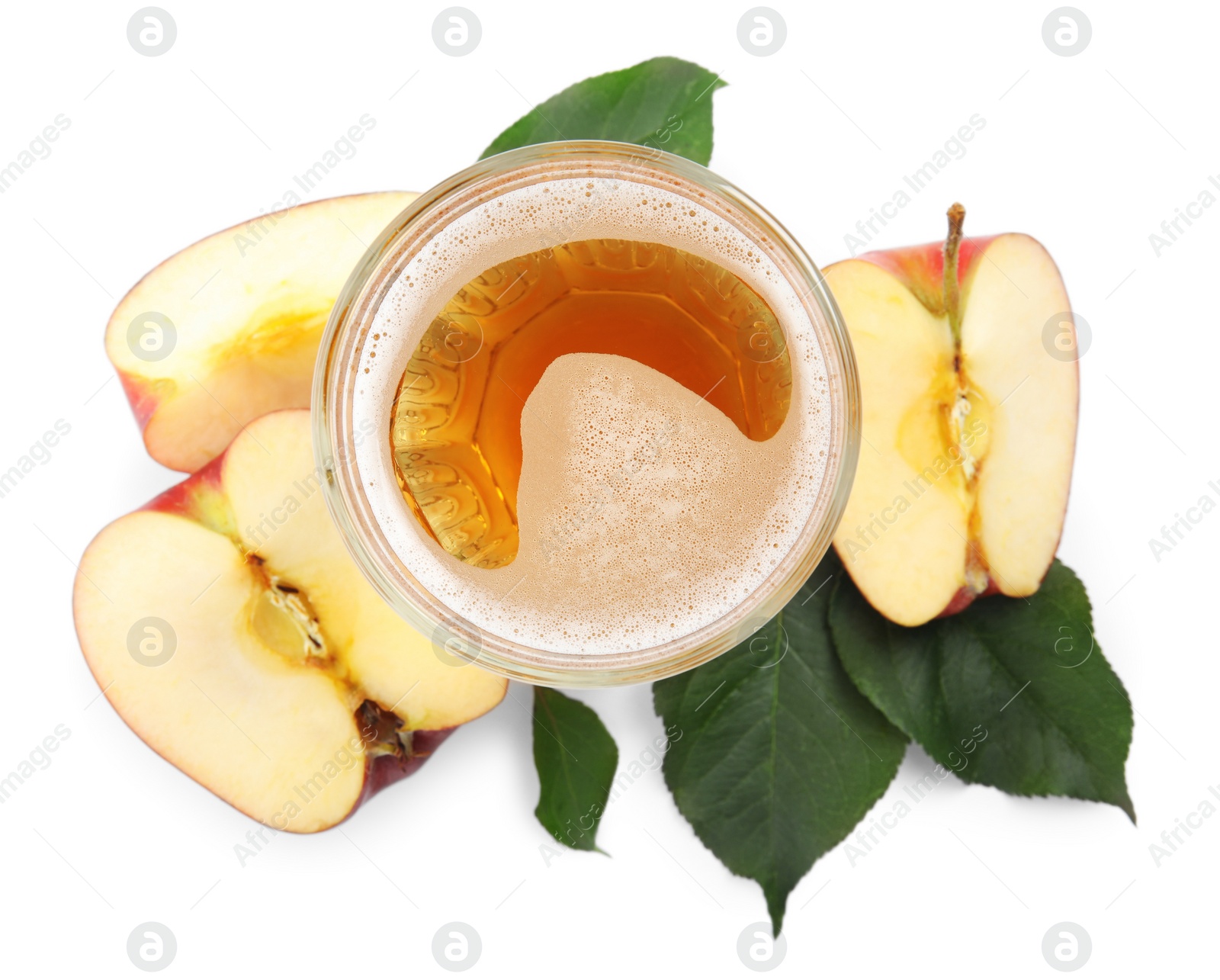 Photo of Delicious cider in glass near pieces of ripe apple on white background, top view