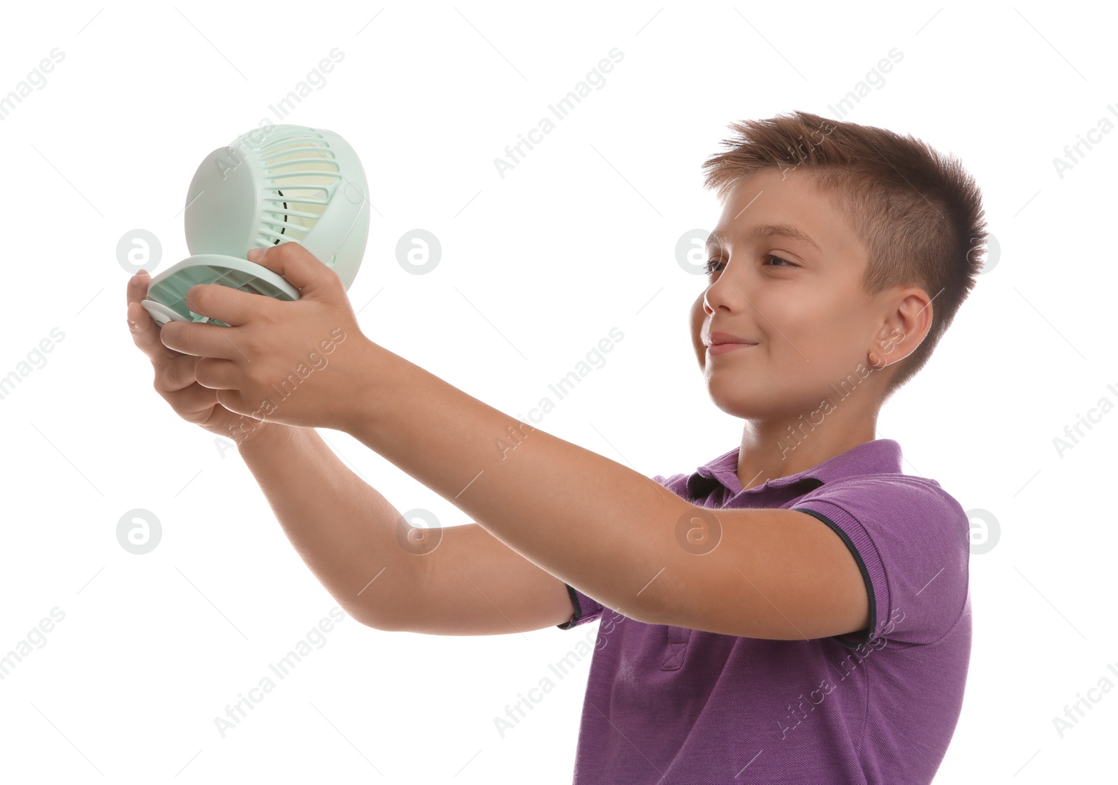 Photo of Little boy enjoying air flow from portable fan on white background. Summer heat