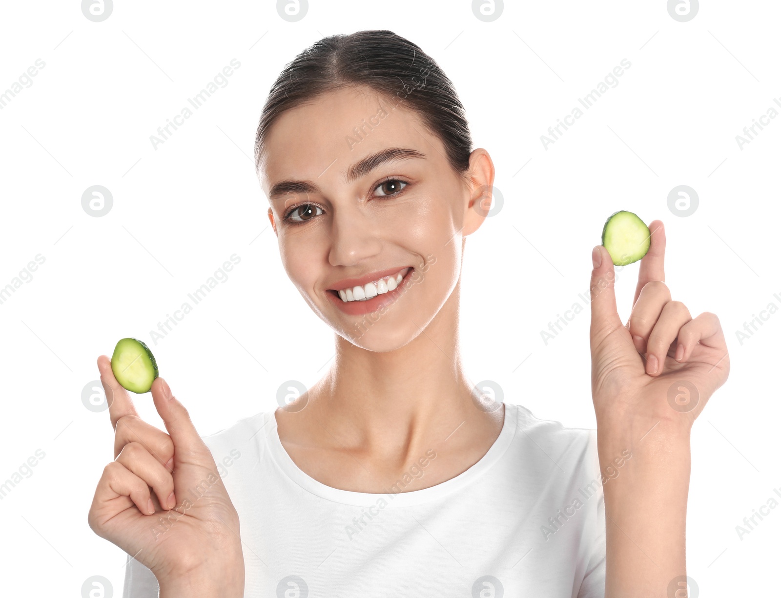 Photo of Happy young woman with cucumber slices on white background. Organic face mask