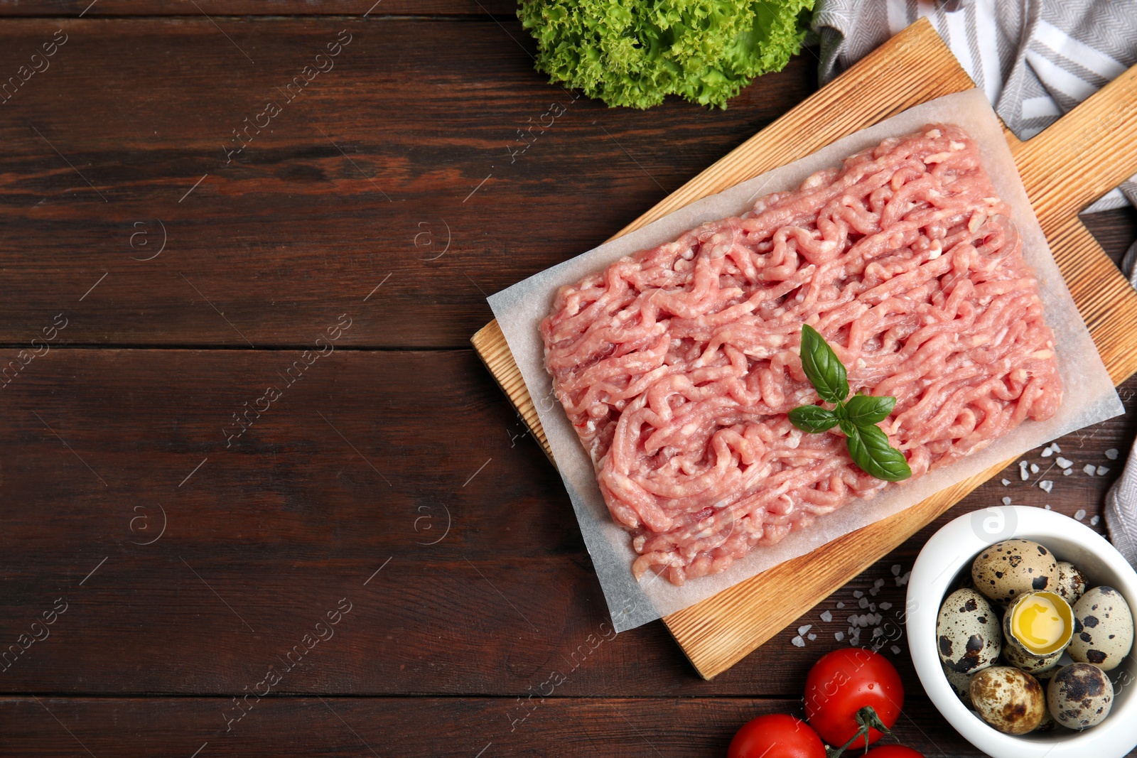 Photo of Raw chicken minced meat and ingredients on wooden table, flat lay. Space for text