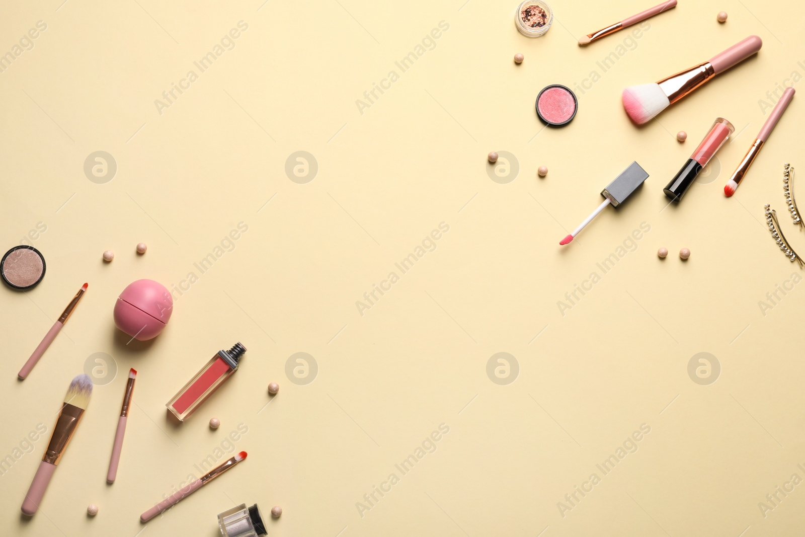 Photo of Flat lay composition with makeup brushes on beige background. Space for text
