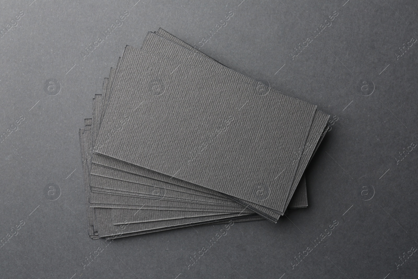 Photo of Blank business cards on black background, top view. Mockup for design