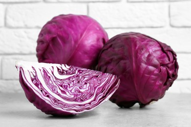 Photo of Closeup view of fresh red cabbages on white table
