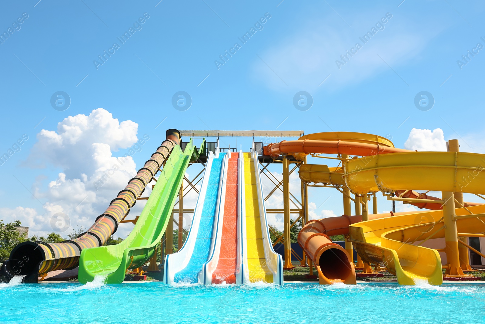 Photo of Different colorful slides in water park on sunny day