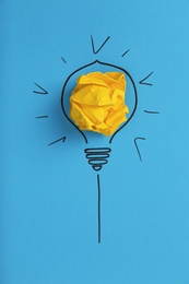 Photo of Composition with crumpled paper ball and drawing of lamp bulb on color background, top view. Creative concept