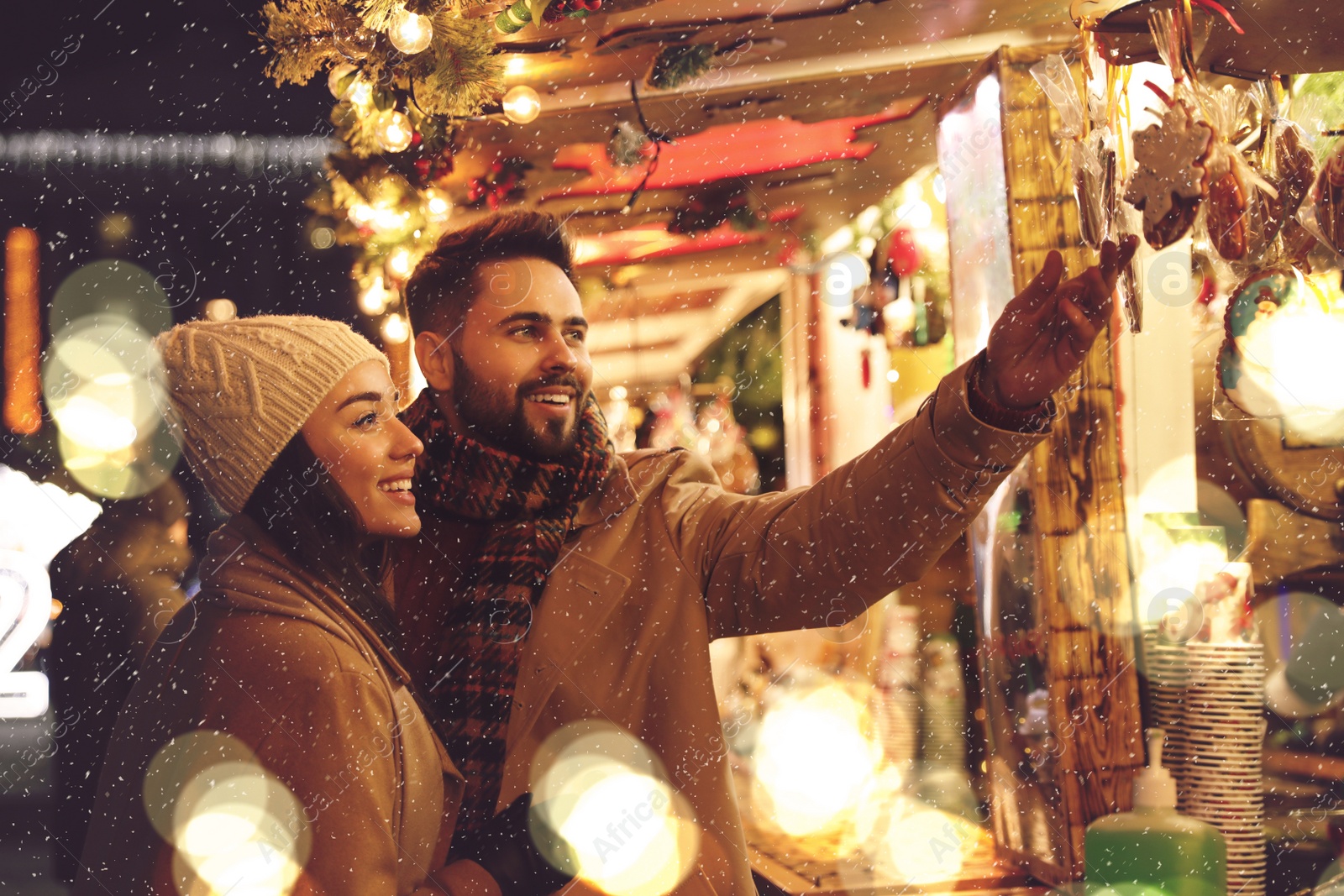 Image of Lovely couple spending time together at Christmas fair