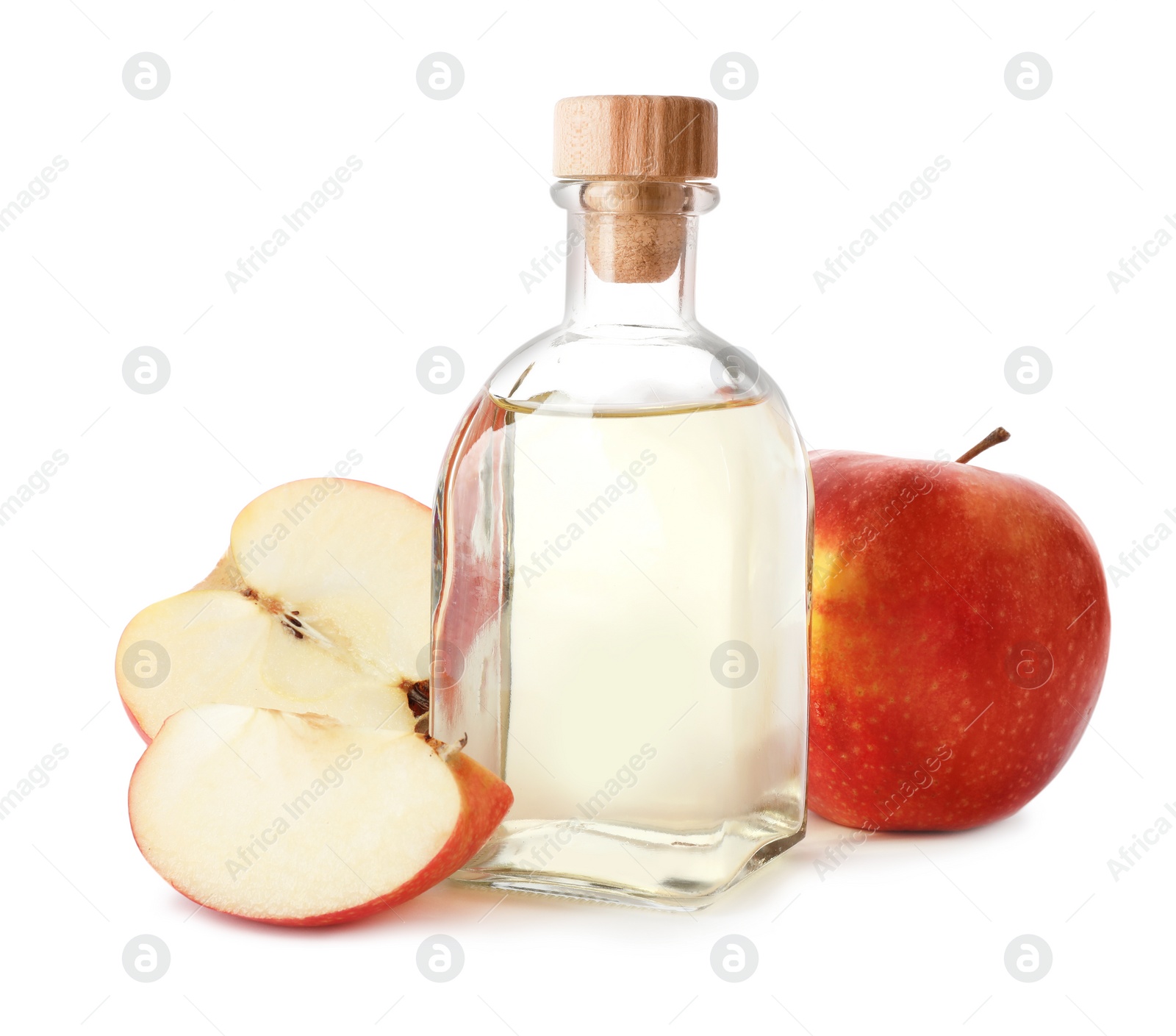 Photo of Glass bottle of vinegar and fresh apples on white background