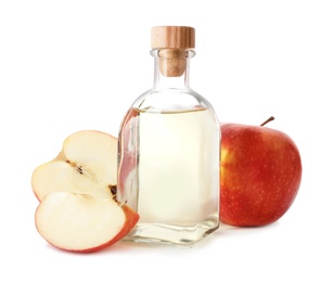 Photo of Glass bottle of vinegar and fresh apples on white background
