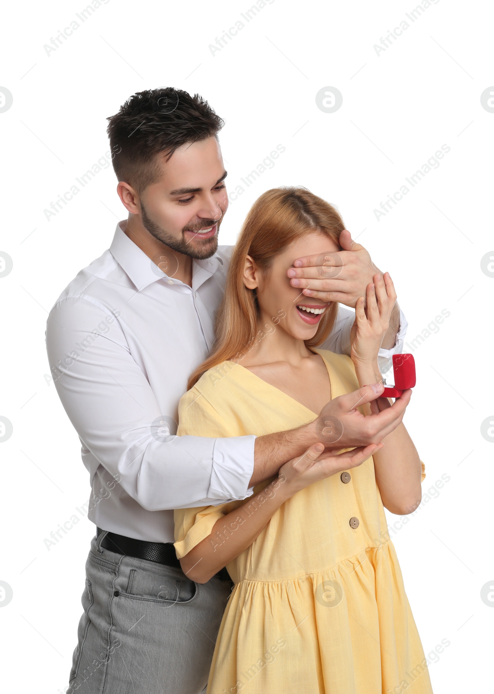 Photo of Man with engagement ring making marriage proposal to girlfriend on white background