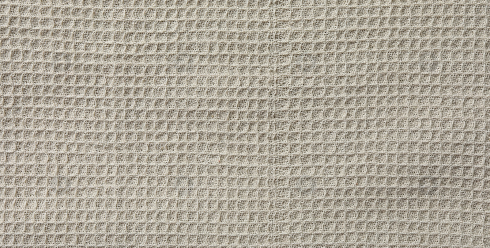 Photo of Texture of beige knitted fabric as background, top view