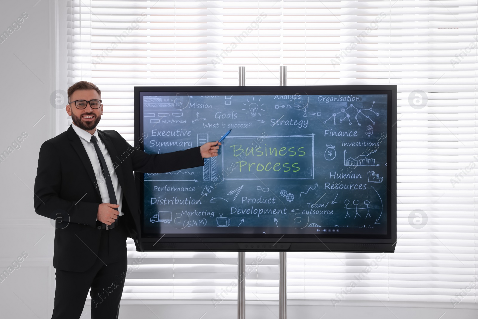 Photo of Business trainer using interactive board in meeting room during presentation