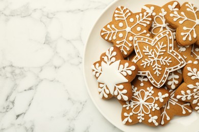 Tasty star shaped Christmas cookies with icing on white marble table, top view. Space for text