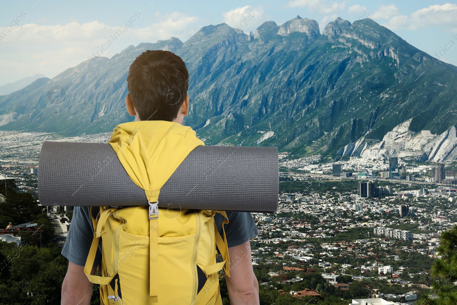 Image of Tourist with backpack in mountains, back view