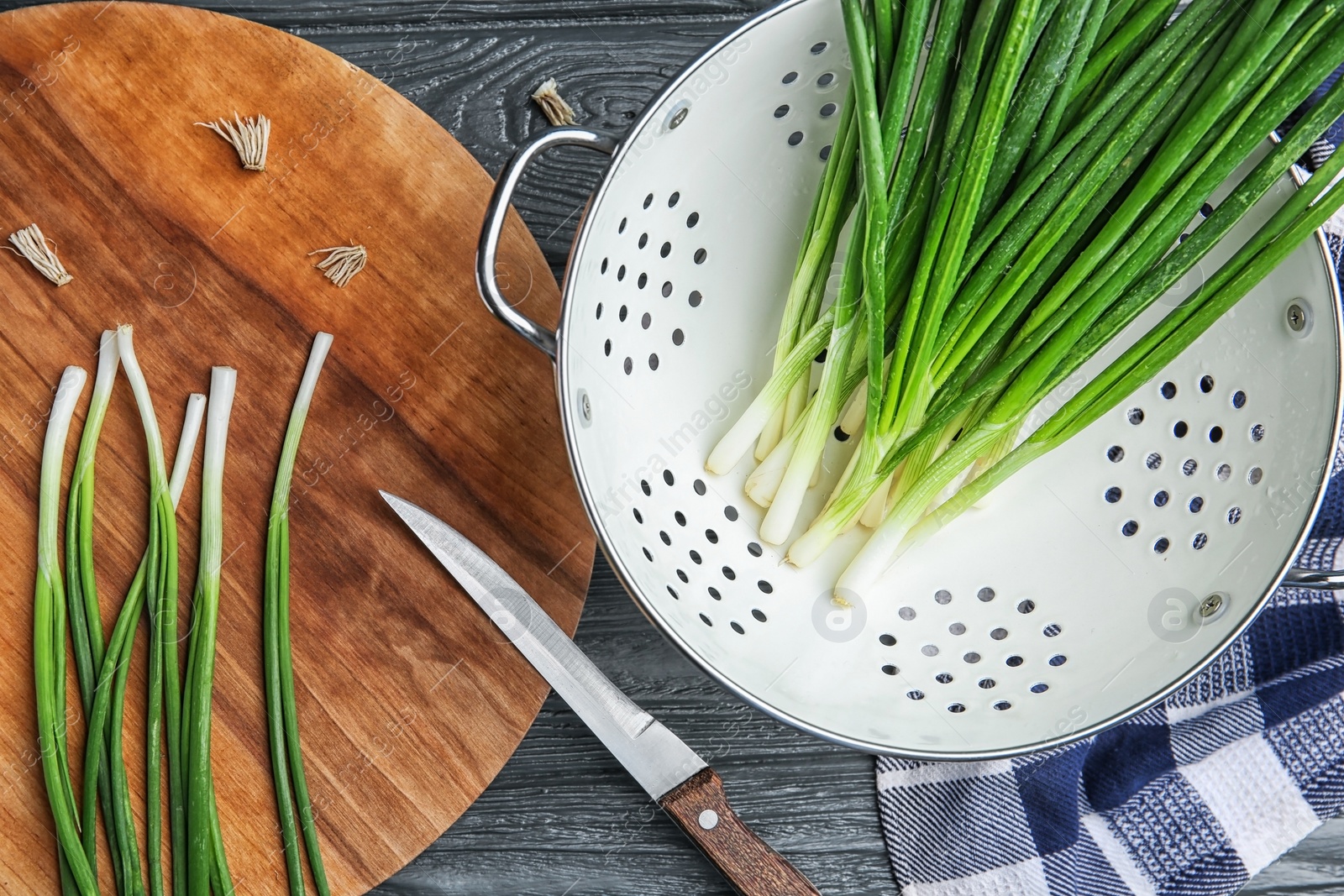 Photo of Beautiful composition with fresh green onion on table, top view