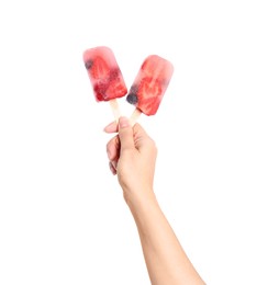 Photo of Woman holding berry popsicles on white background, closeup
