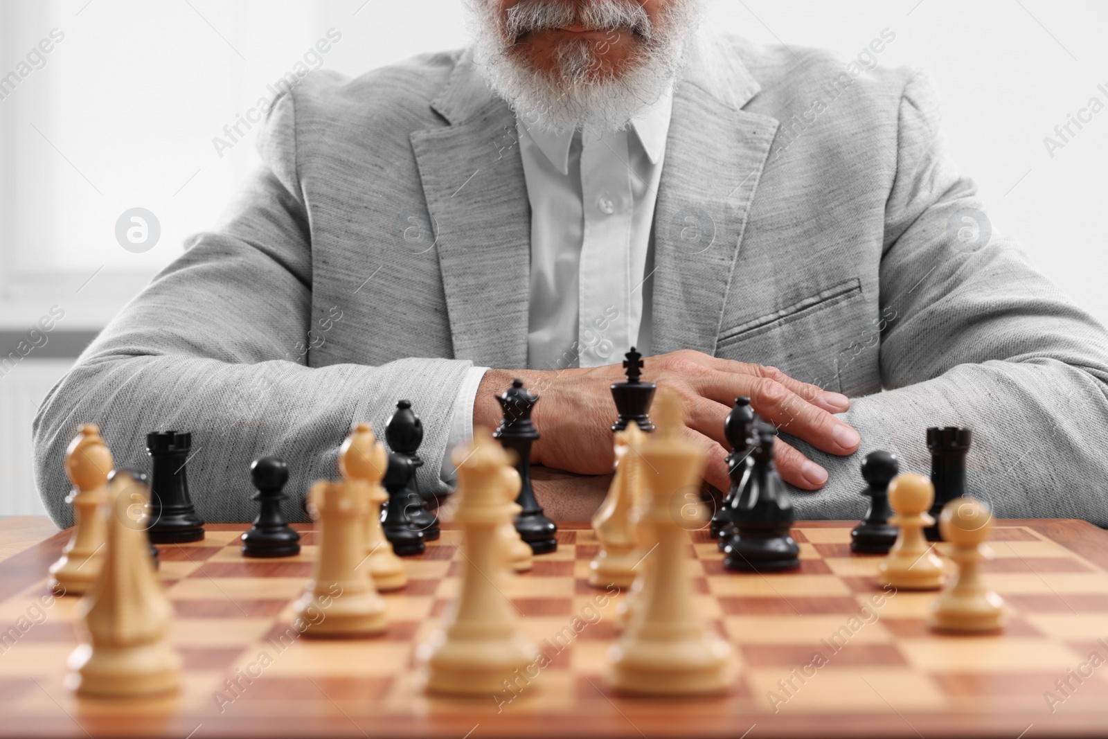 Photo of Man playing chess during tournament at chessboard, closeup