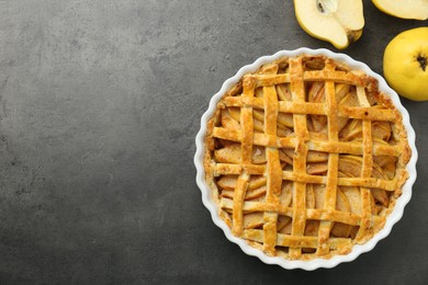 Photo of Tasty homemade quince pie and fresh fruits on grey table, flat lay. Space for text