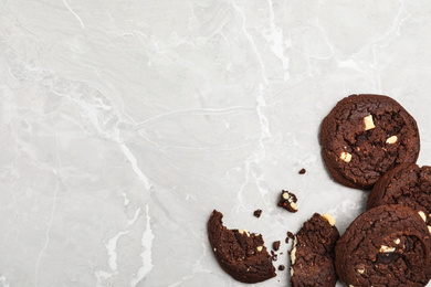 Delicious chocolate cookies on marble table, flat lay. Space for text