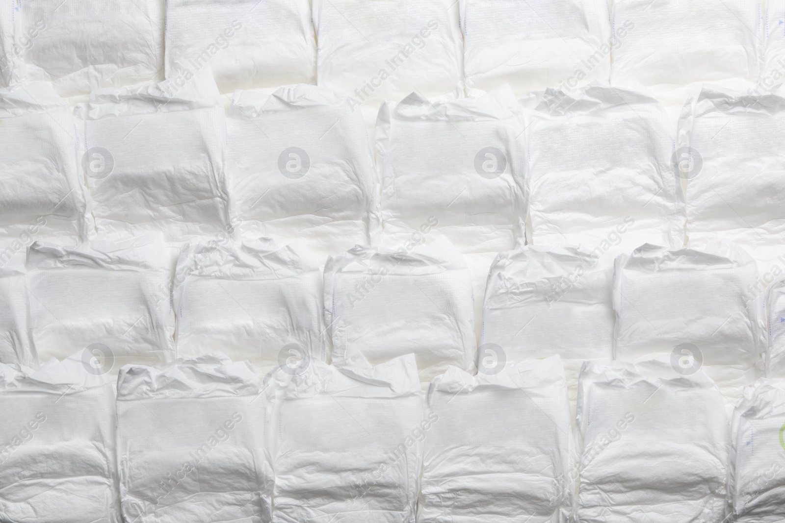 Photo of Baby diapers as background, top view. Child's garment