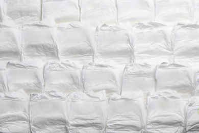 Photo of Baby diapers as background, top view. Child's garment