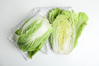 Photo of Fresh ripe Chinese cabbages on white table, top view