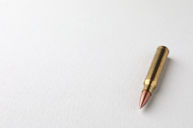 Photo of Bullet on white background, closeup. Space for text