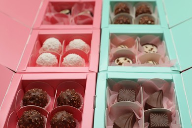 Photo of Many delicious candies in boxes, closeup. Production line