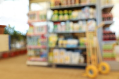 Photo of Blurred view of gardening shop with different supplies