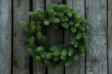 Beautiful Christmas wreath hanging on wooden wall