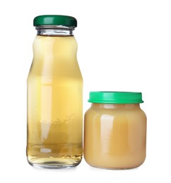 Photo of Baby food in jar near bottle of juice on white background