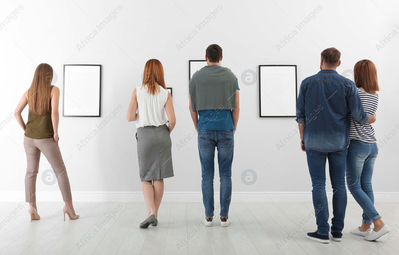 Photo of People viewing exposition in modern art gallery