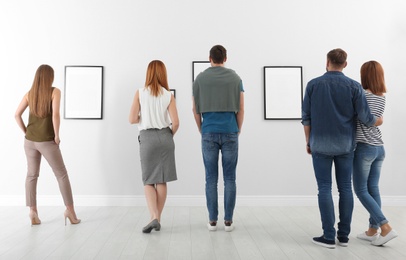 People viewing exposition in modern art gallery