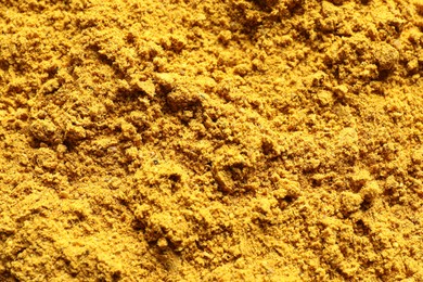 Dry curry powder as background, top view