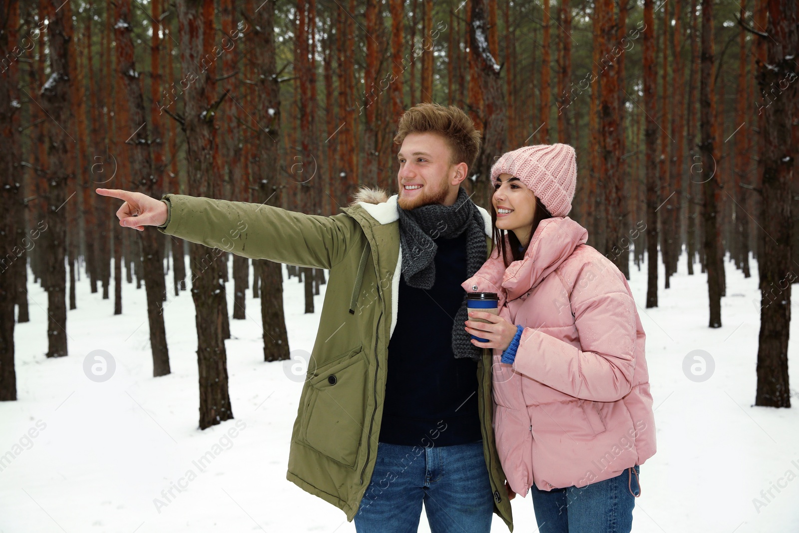 Photo of Beautiful young couple in snowy winter forest