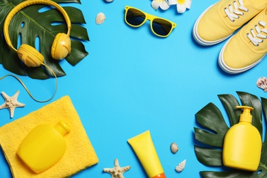 Flat lay composition with beach accessories on color background, space for text