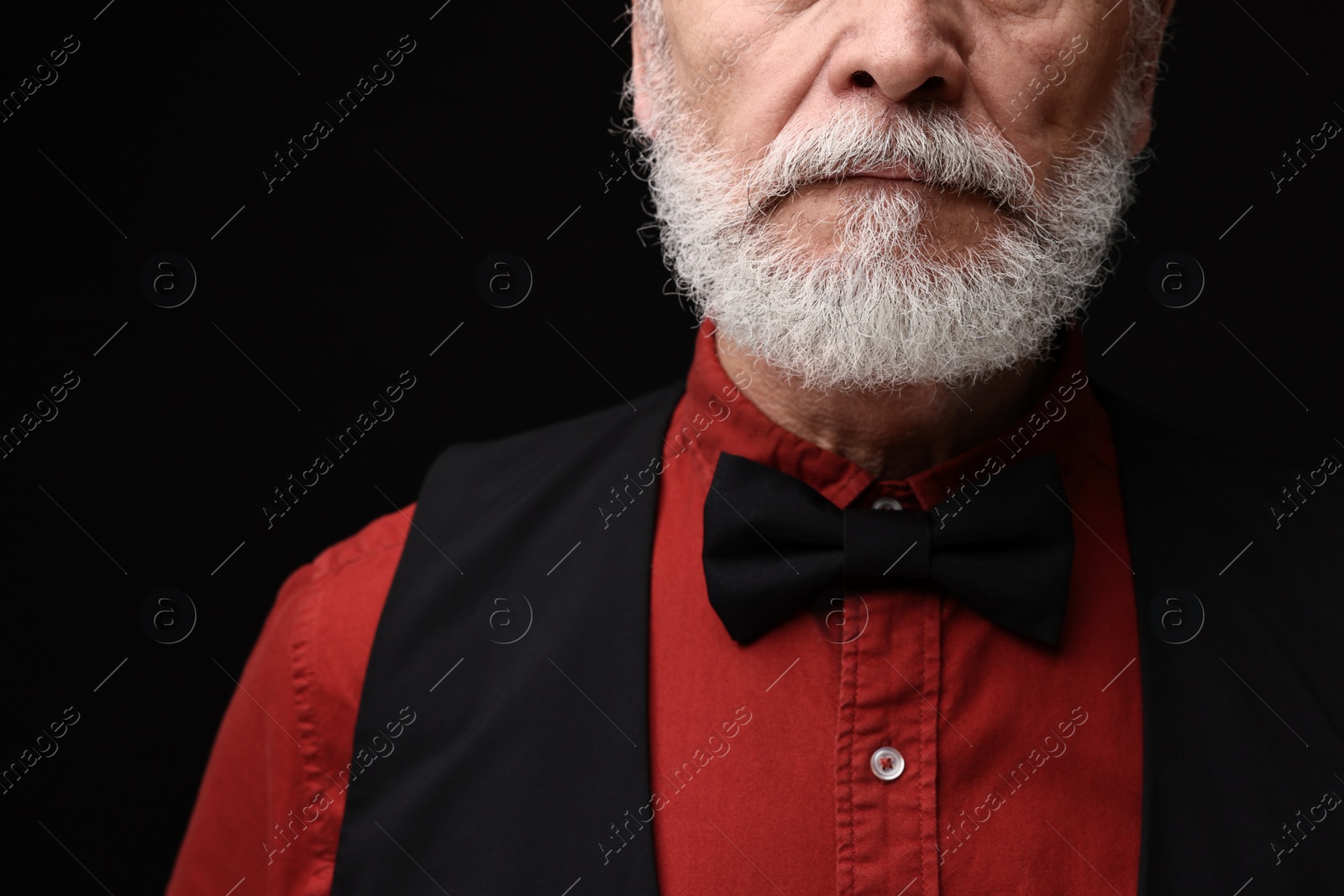 Photo of Man with mustache on black background, closeup