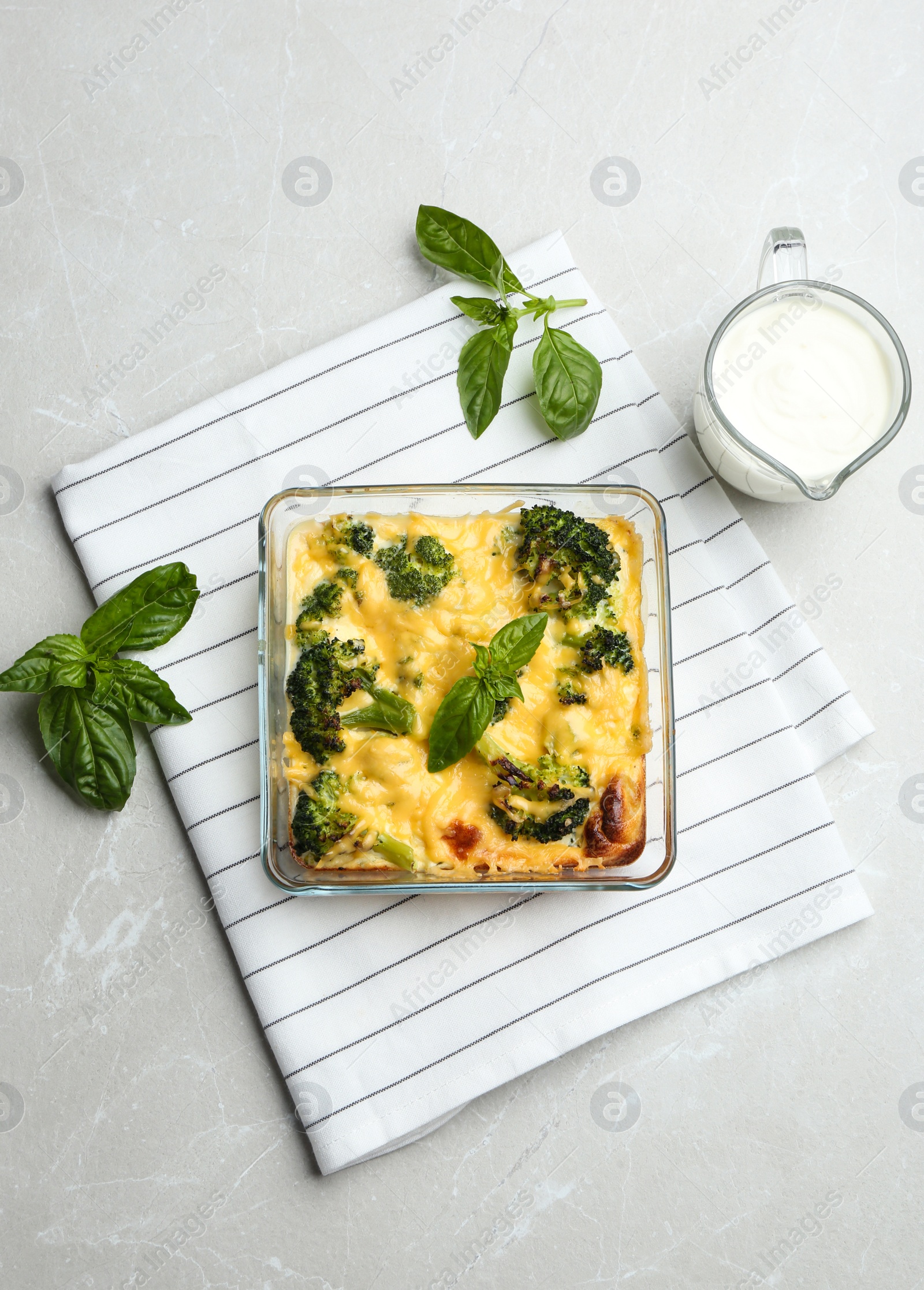 Photo of Flat lay composition with tasty broccoli casserole on grey marble table