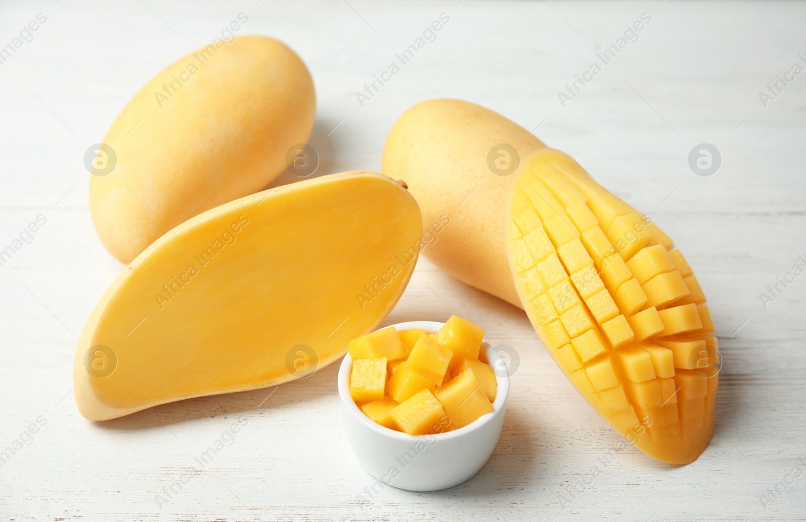 Photo of Composition with fresh juicy mango on wooden table