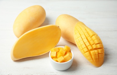 Composition with fresh juicy mango on wooden table