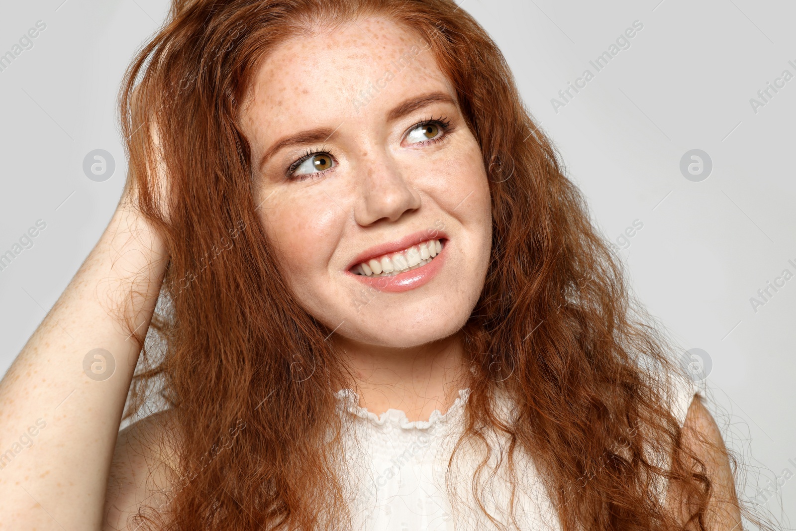 Photo of Portrait of young woman with beautiful face on grey background, closeup