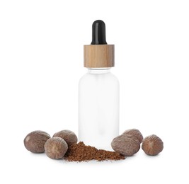Bottle of nutmeg oil, nuts and powder on white background