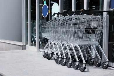 Row of shopping carts near store outdoors