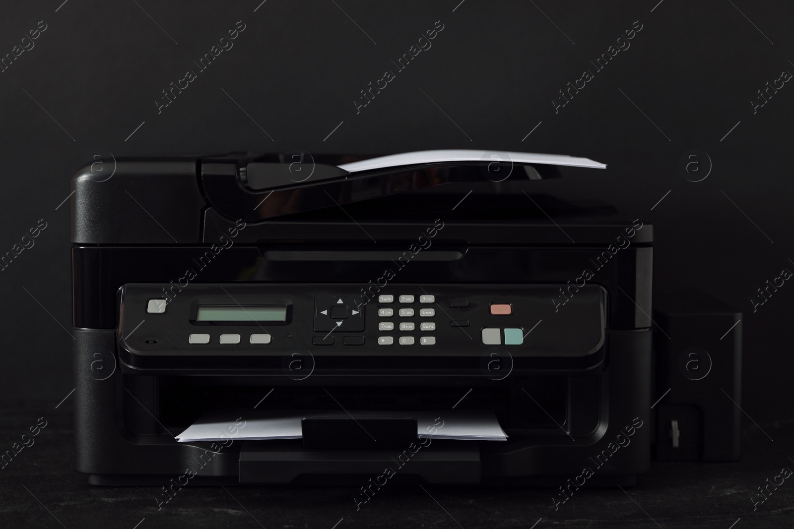 Photo of Modern printer with paper on black background