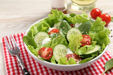 Photo of Delicious salad served on white wooden table, closeup