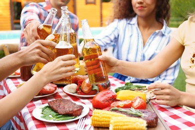 Friends with drinks at barbecue party outdoors, closeup