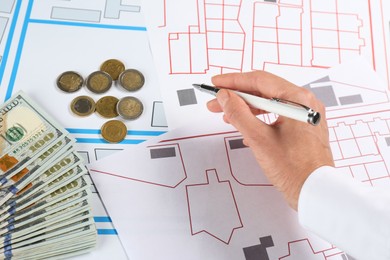 Photo of Cartographer with money drawing cadastral map, closeup