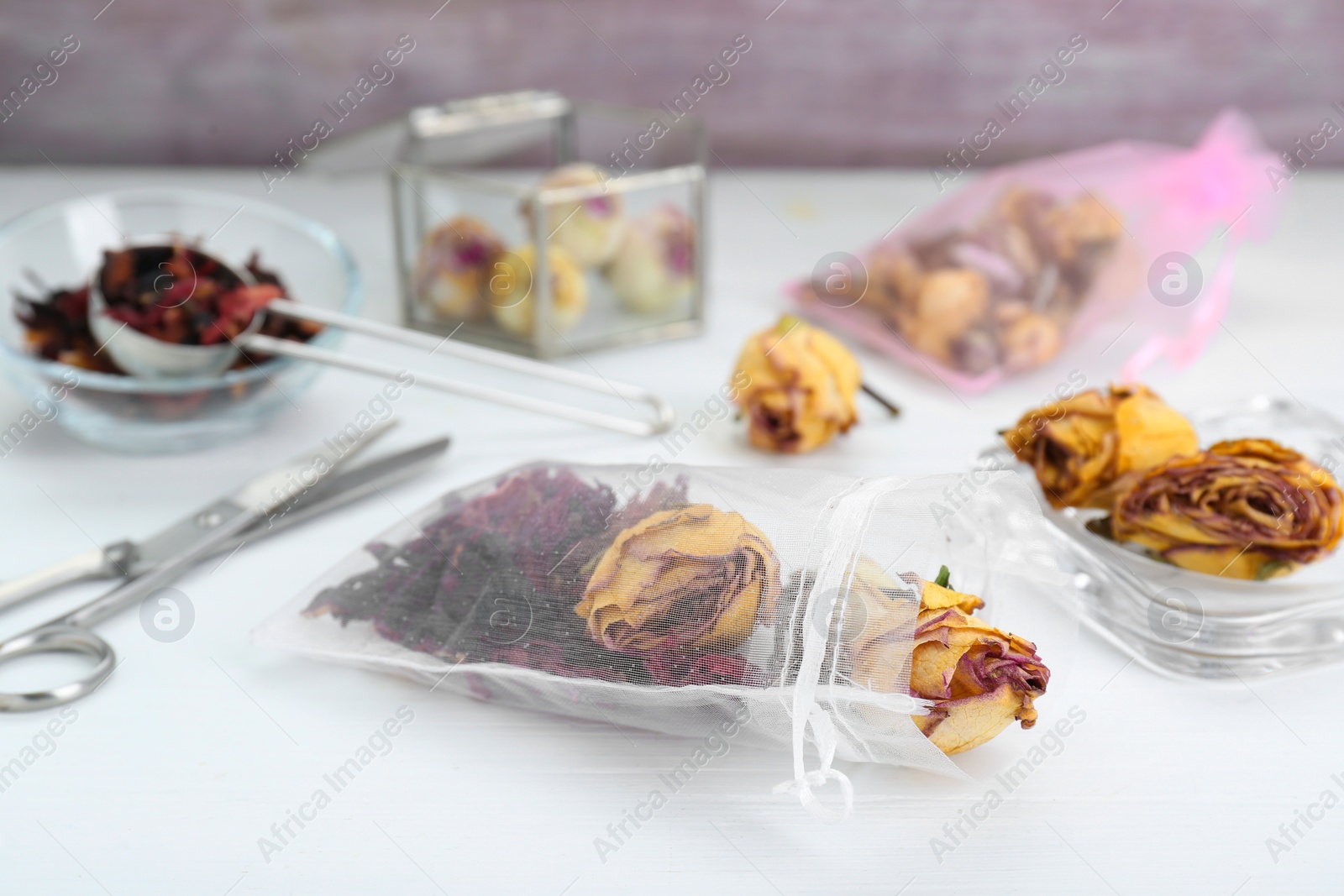 Photo of Scented sachet with dried flowers on white table